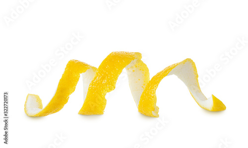 Yellow ripe citrus lemon peel in spiral shape isolated on white background, close-up