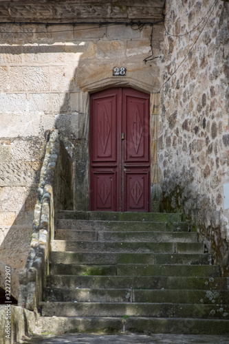 View at a medieval entrance door with a staircase, on a traditional urban building house on Viseu city Downtown © Miguel Almeida