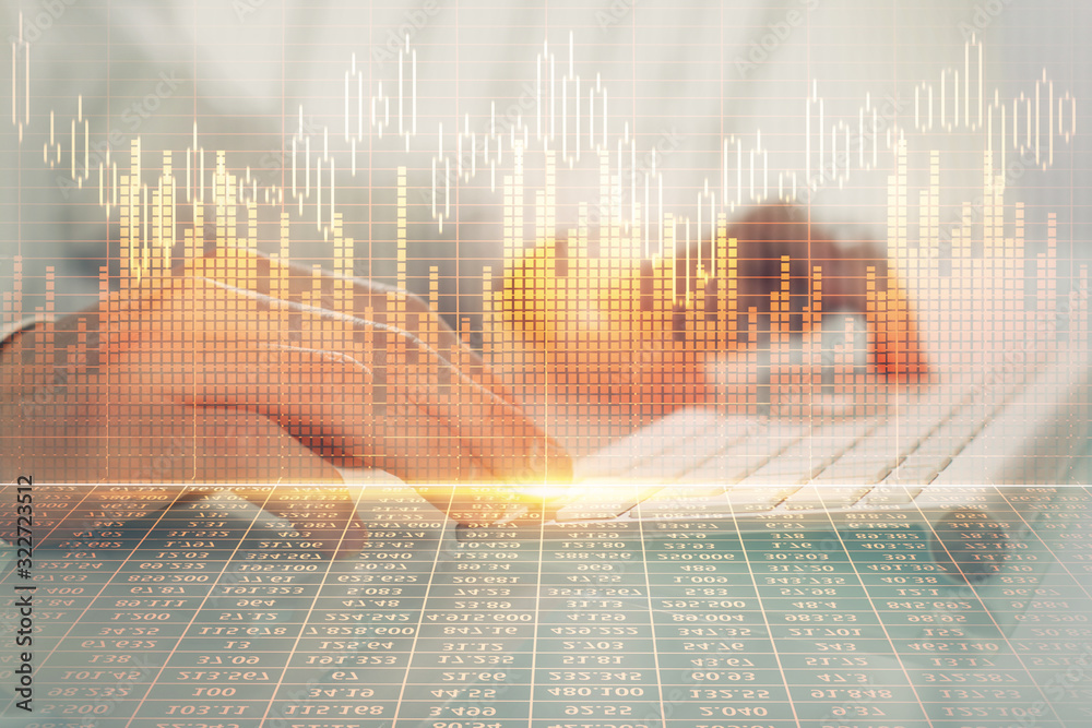 Double exposure of graph with man typing on computer in office on background. Concept of hard work. Double exposure of graph with man typing on computer in office on background. Concept of hard work.