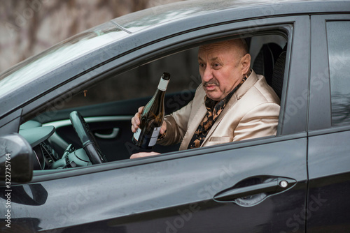 Drunk senior man in automobile. Mature older man problem, crisis lifestyle
