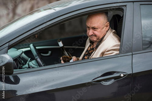 Drunk senior man in automobile. Mature older man problem, crisis lifestyle
