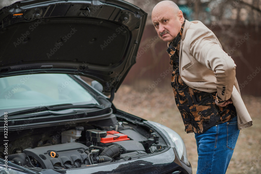 Senior man have a trouble automobile. Mature older man with a car problem, lifestyle 
