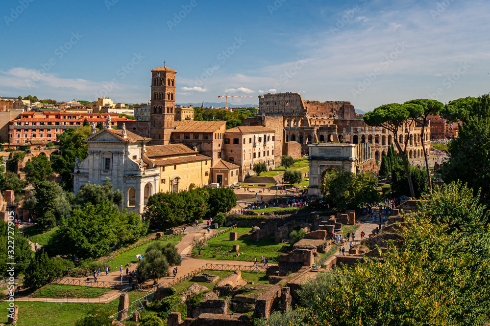 Panoramic view of the ancient ruins of Forum Romanum from the hill of Palatino at a summer day near Collosseum in the city of Rome, Italy