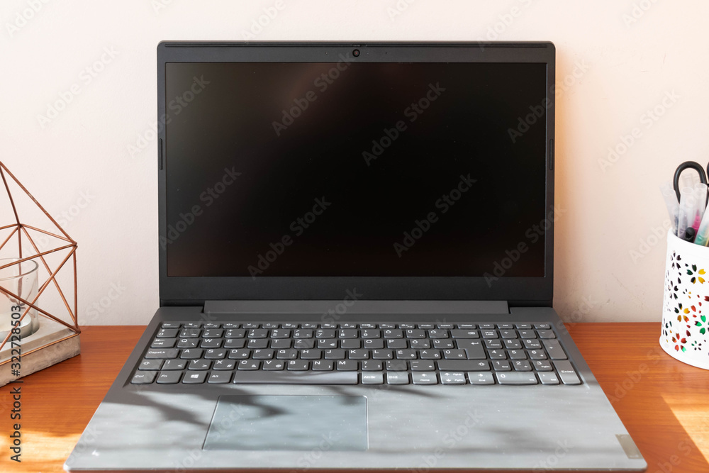 Grey laptop on office desk Grey laptop on office desk