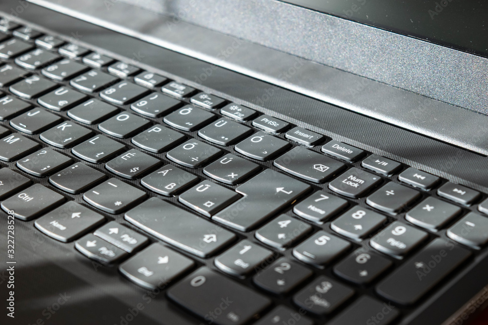 Grey laptop keyboard closeup background Grey laptop keyboard closeup background