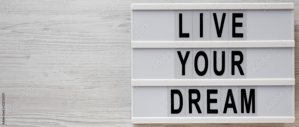 'Live your dream' words on a modern board on a white wooden background, top view. Overhead, from above, flat lay. Copy space. 'Live your dream' words on a modern board on a white wooden background, top view. Overhead, from above, flat lay. Copy space.