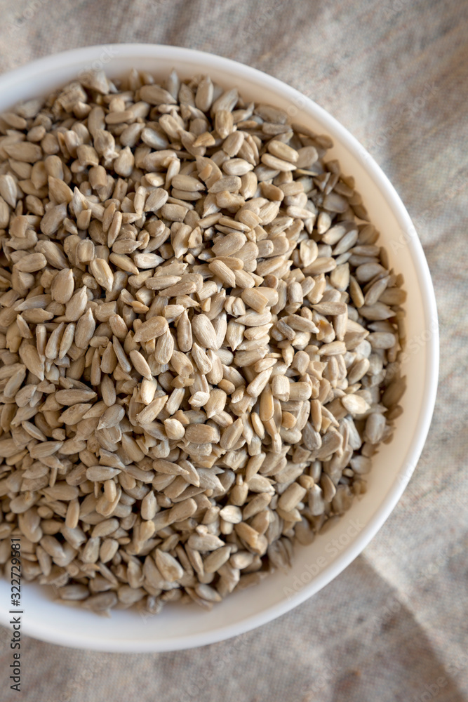 Overhead view, Raw Sunflower Seed Kernels in a white bowl. Flat lay, top view, from above. Overhead view, Raw Sunflower Seed Kernels in a white bowl. Flat lay, top view, from above.