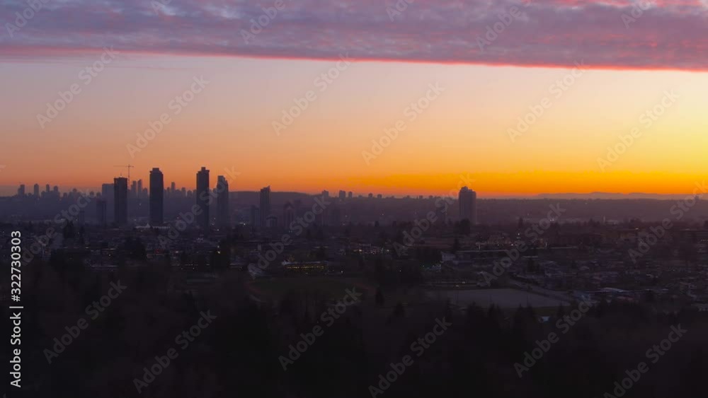 Aerial Panoramic View of a modern city during a colorful and cloudy sunset. Taken in Burnaby, Greater Vancouver, British Columbia, Canada. Aerial Panoramic View of a modern city during a colorful and cloudy sunset. Taken in Burnaby, Greater Vancouver, British Columbia, Canada.