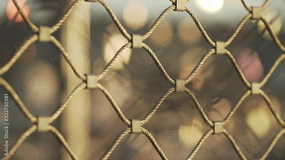 Close Up shot of metal fence with beautiful light bokeh Close Up shot of metal fence with beautiful light bokeh