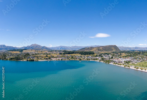 Beautiful panoramic high angle aerial drone view of the town of Wanaka, a popular ski and summer resort town located at Lake Wanaka in the Otago region of the South Island of New Zealand.