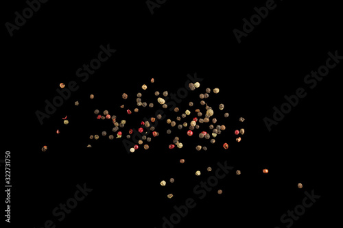 Fototapeta Naklejka Na Ścianę i Meble -  Whole coloured pepper spice flying in the air close up. Zero gravity concept.