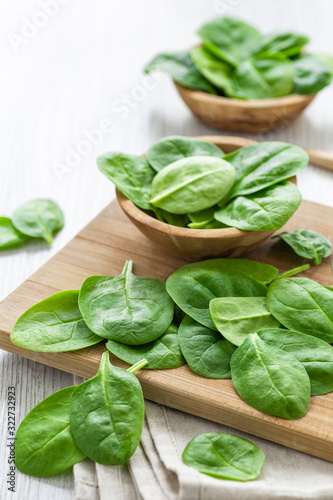 Fresh green leaves spinach on a wooden cutting board