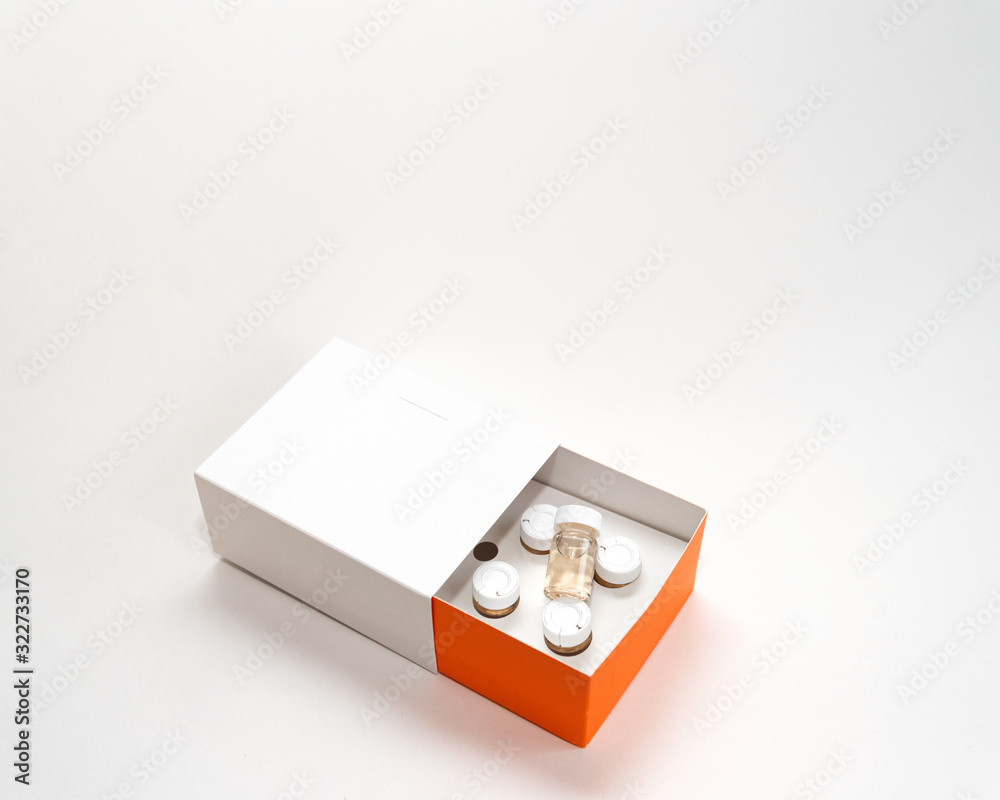 white box with jars inside with orange sideways on a white background white box with jars inside with orange sideways on a white background