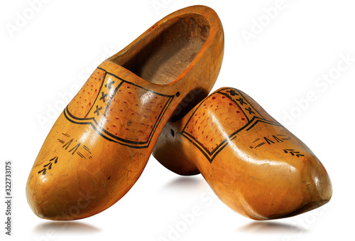 Fototapeta Close-up of a pair of wooden clogs made in Netherlands, isolated on white backgr
