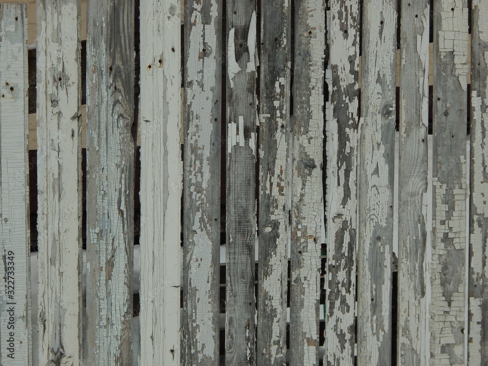 old wooden plank fence with peeling white paint old wooden plank fence with peeling white paint