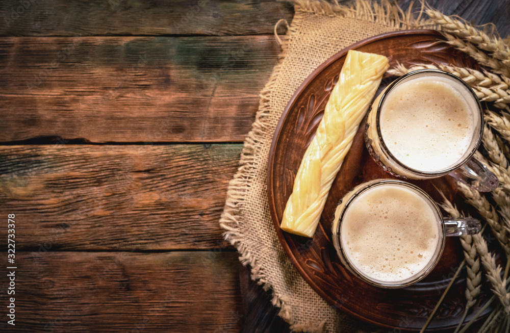 Dark beer in the mug on the wooden table background with copy space. Dark beer in the mug on the wooden table background with copy space.