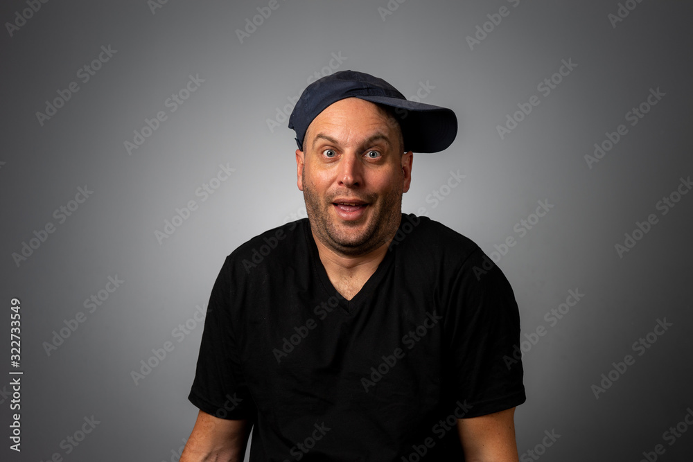 man in black vneck teeshirt and backwards hat man in black vneck teeshirt and backwards hat