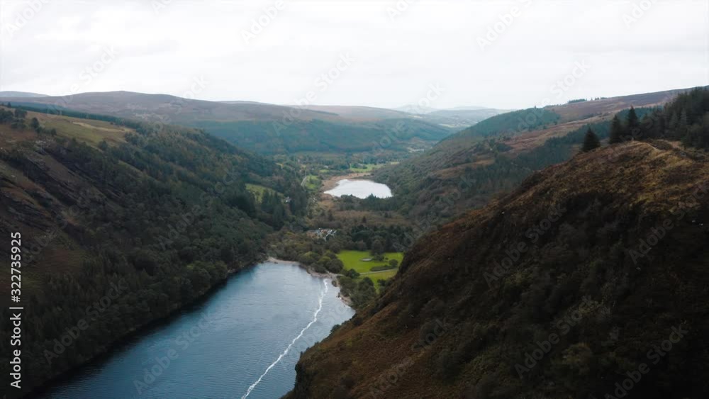 The Glendalough Lake in Wicklow. The drone is flying towards it with also moving the camera down making an cinematic scene. The Glendalough Lake in Wicklow. The drone is flying towards it with also moving the camera down making an cinematic scene.