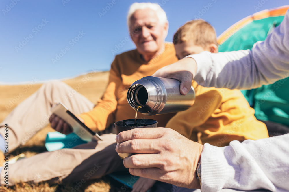 Three generations of family camping together in the autumn. Three generations of family camping together in the autumn.
