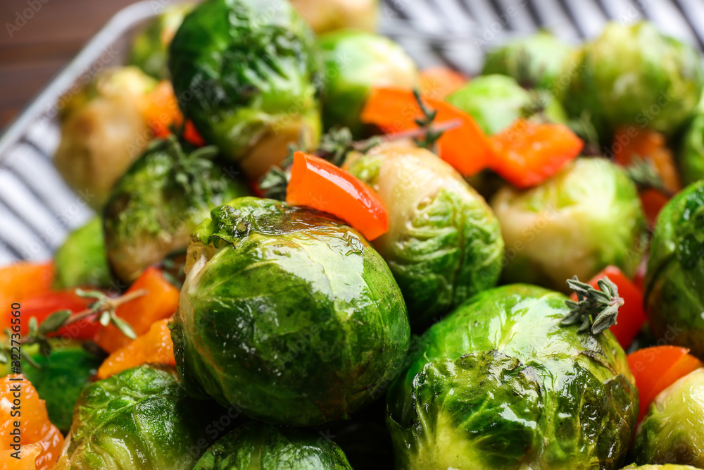 Delicious roasted Brussels sprouts with bell pepper as background, closeup Delicious roasted Brussels sprouts with bell pepper as background, closeup