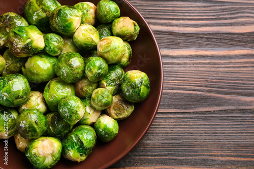 Delicious roasted Brussels sprouts on wooden table, top view © New Africa