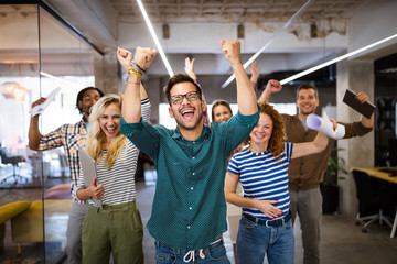 Happy business people celebrating success at company