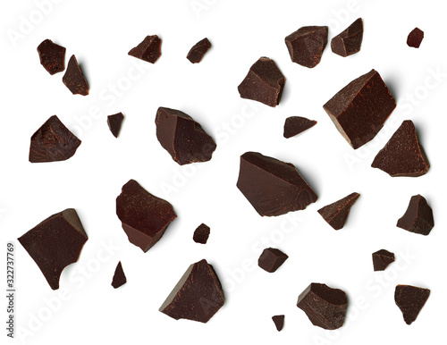 Broken, cracked or crushed dark chocolate parts from top view isolated on white background