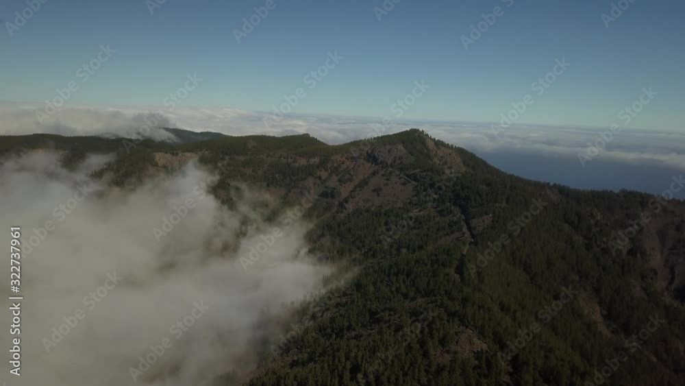 Huge mountain covered with forests, white fluffy cloud is floating next to it 4k Huge mountain covered with forests, white fluffy cloud is floating next to it 4k