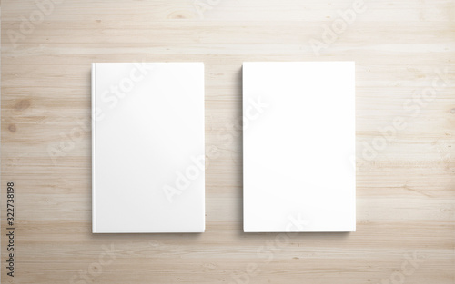 2 Book with white hardcover on wooden desk. 