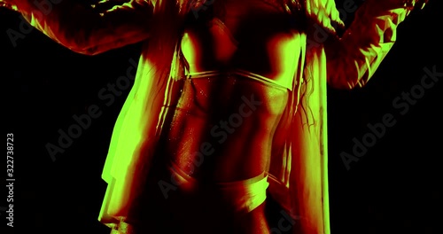 Club party. Nightlife. Slender beautiful girl dancing in the club under the colored rays of neon lights disco. Bright installation iridescent juicy colors