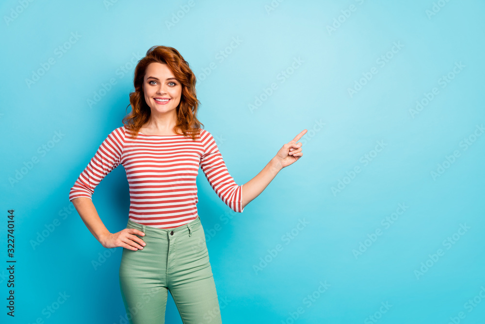Portrait of confident positive girl point index finger copyspace recommend suggest select ads promo wear good look jumper isolated over blue color background Portrait of confident positive girl point index finger copyspace recommend suggest select ads promo wear good look jumper isolated over blue color background