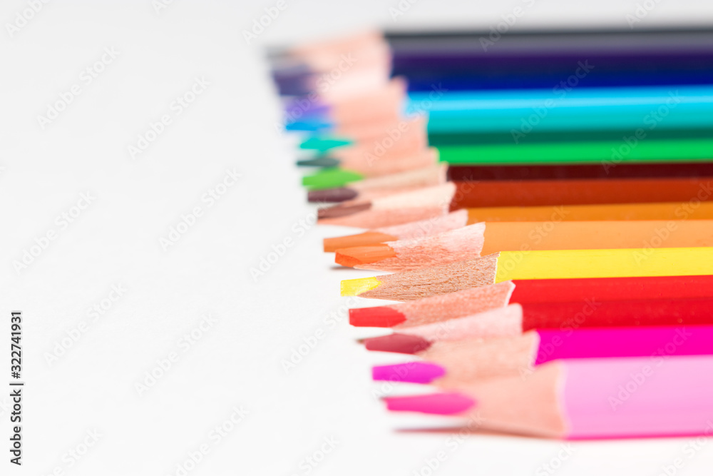 color pencils in order on a white background