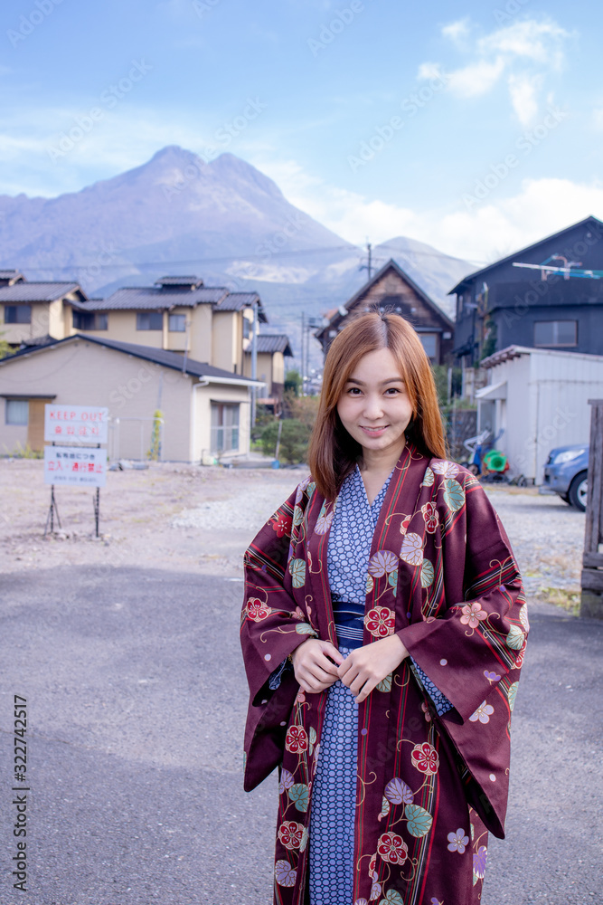 Fototapeta premium Lovely Asian Girl wearing Yukata japanese tradditional cloth in traddition Japan style in Tatami room. Face on happy time in Japan with copy space.