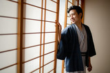 Lovely Asian man wearing Yukata japanese tradditional cloth in traddition Japan style  in Tatami room. Face on happy time in Japan with copy space.
