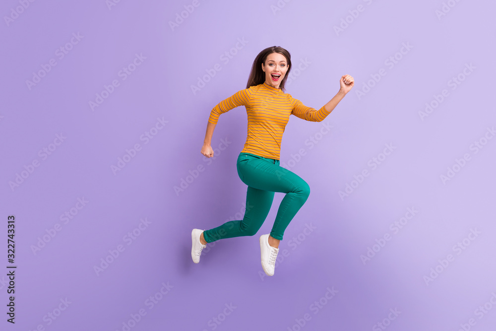 Full length body size view of nice attractive lovely cheerful cheery glad excited energetic girl jumping running fast movement isolated on violet purple lilac pastel color background