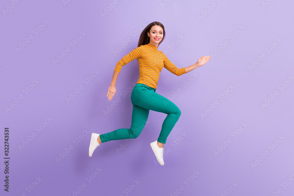 Full length body size view of her she nice attractive lovely cheerful cheery glad confident strong energetic girl running fast active life soul isolated on violet purple lilac pastel color background