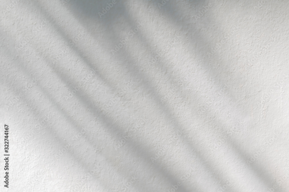 Nature gray shadow and light abstract background. Leaf and tree shadows bokeh with sunlight on white concrete wall texture Nature gray shadow and light abstract background. Leaf and tree shadows bokeh with sunlight on white concrete wall texture