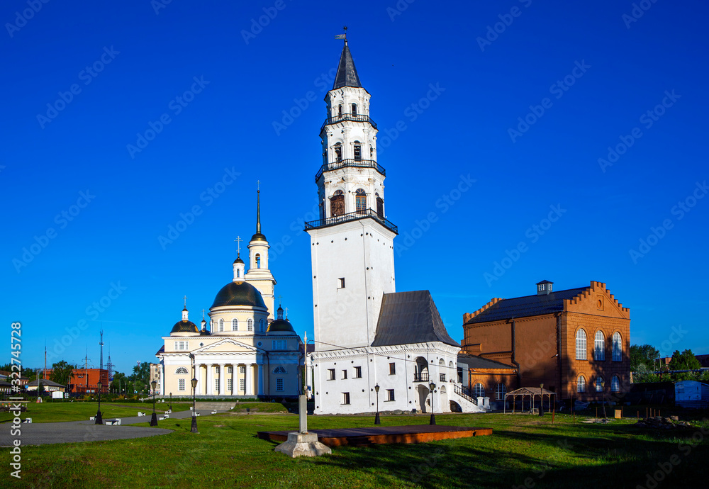 The inclined tower of Demidov, Transfiguration Cathedral and the building of the former power plant. Nevyansk. Sverdlovsk region. Russia