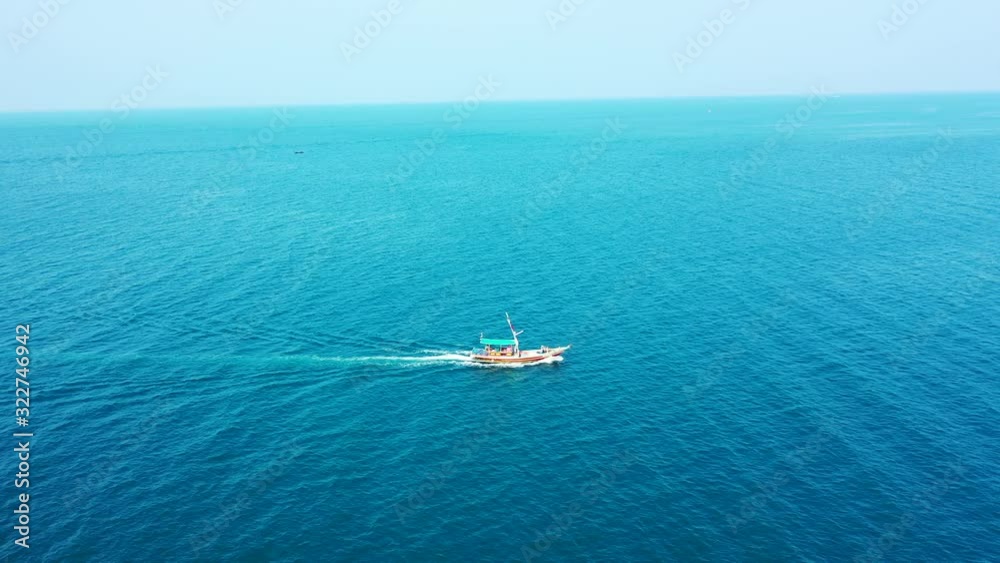 Touring boat sailing across vibrant blue sea surface on a hot summer day near shore of Turks and Caicos islands, copy space Touring boat sailing across vibrant blue sea surface on a hot summer day near shore of Turks and Caicos islands, copy space