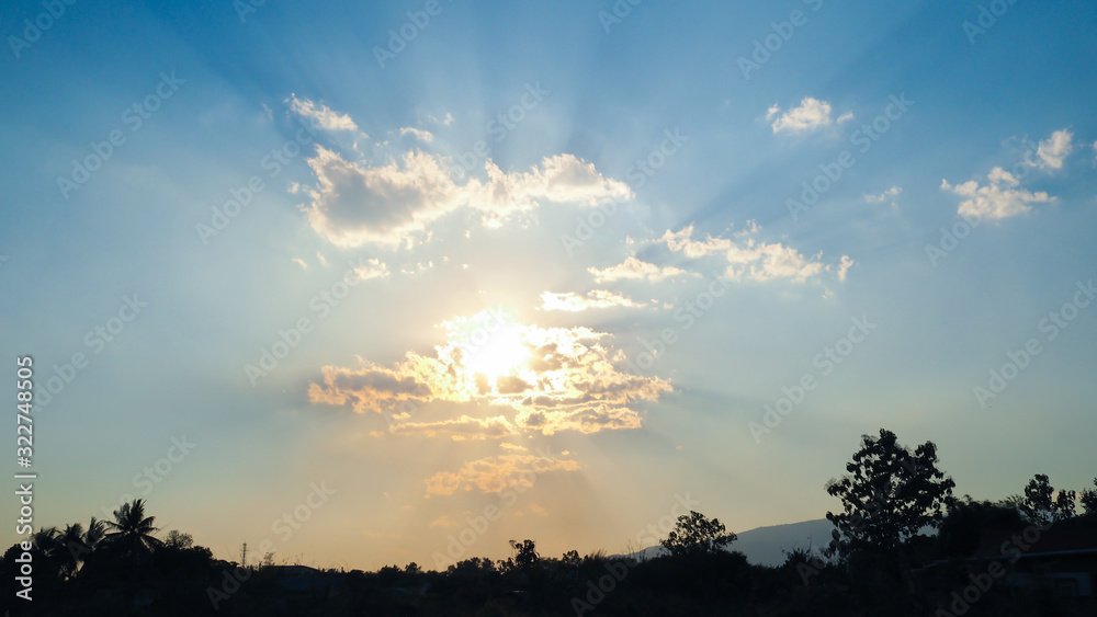 Fototapeta premium Sunset evening with beautiful colour of sun ray spread over. clouds are small but perfect in crown shape. Background sunset.