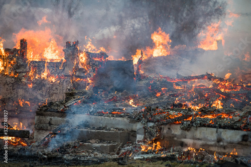 Фотография Norwegian firefighter trying to put out flames house on fire
