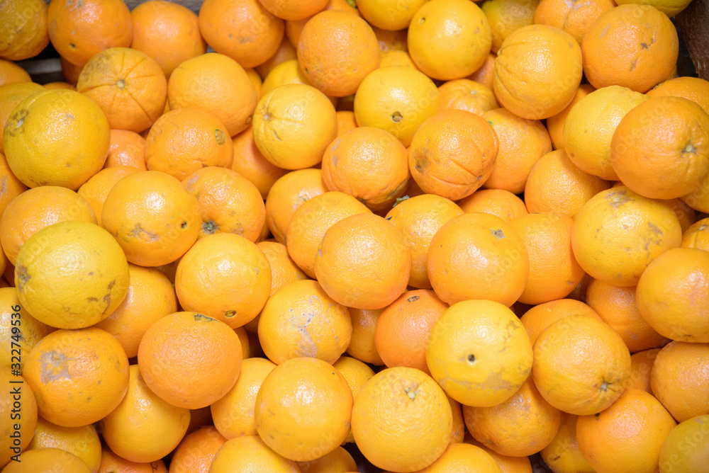 Pile of oranges, freshly produced with imperfections on the skin Pile of oranges, freshly produced with imperfections on the skin