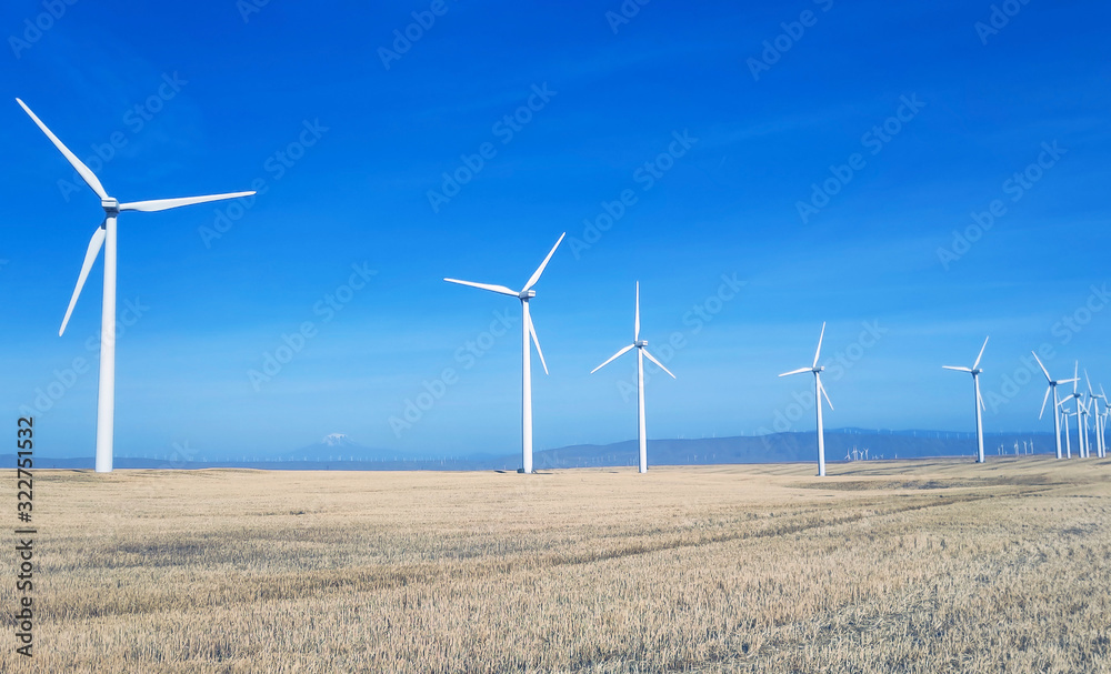Breathtaking view of a lots of windmills with a beautiful blue sky in the mourning in early fall near the Columbia River in Klickitat County Washington State Breathtaking view of a lots of windmills with a beautiful blue sky in the mourning in early fall near the Columbia River in Klickitat County Washington State