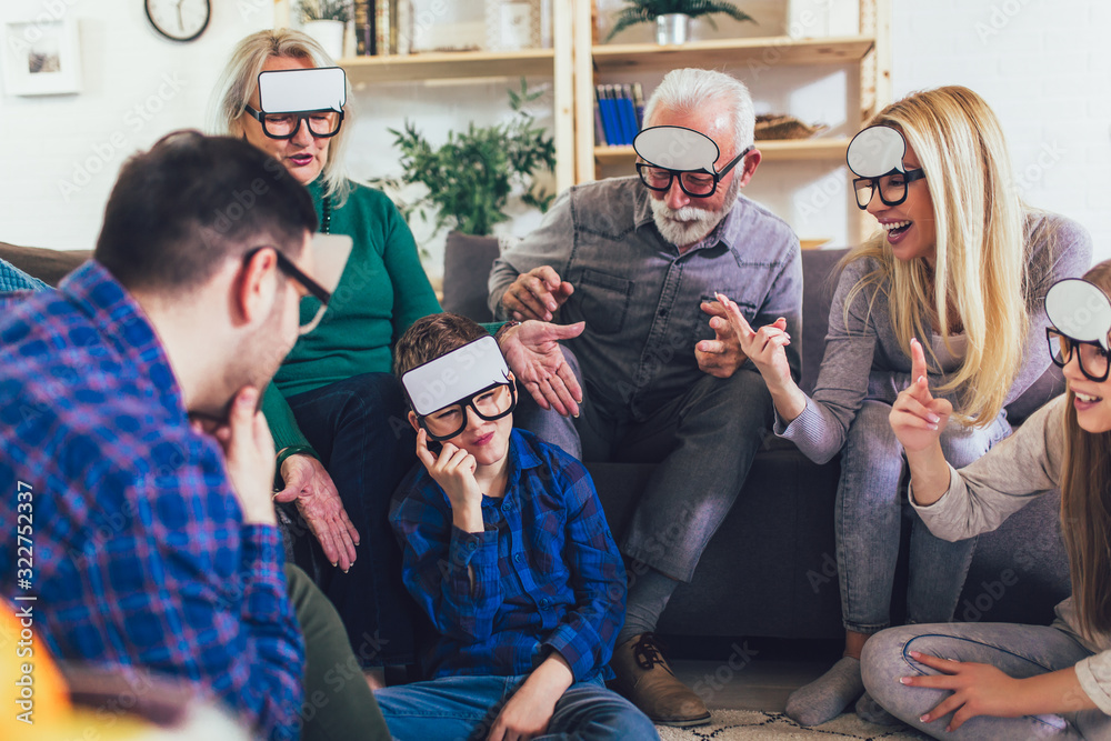 Portrait of a three generation family spending time together at home playing game guess who. Portrait of a three generation family spending time together at home playing game guess who.