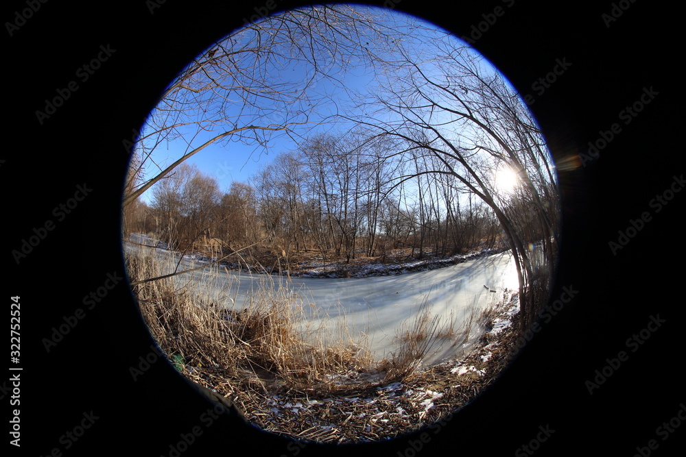 Naklejka premium Frozen river in forest. Circular fisheye landscape