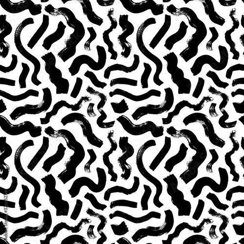 Scattered wavy brushstrokes hand drawn vector seamless pattern. Monochrome printmaking texture.