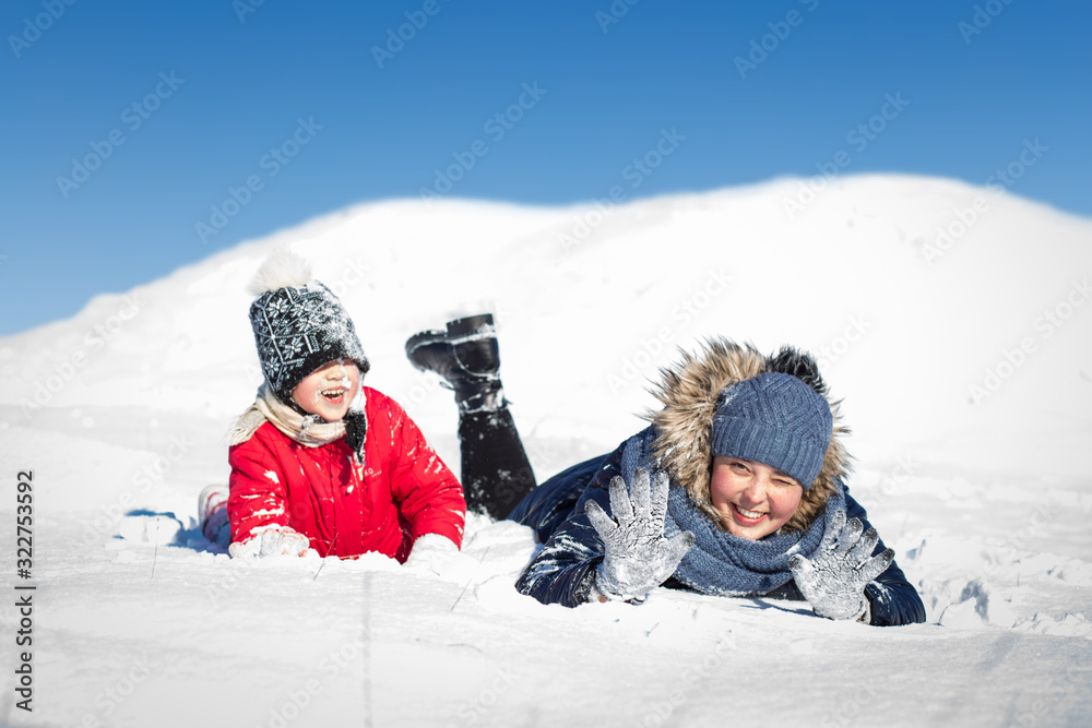 mom and daughter have fun in the snow