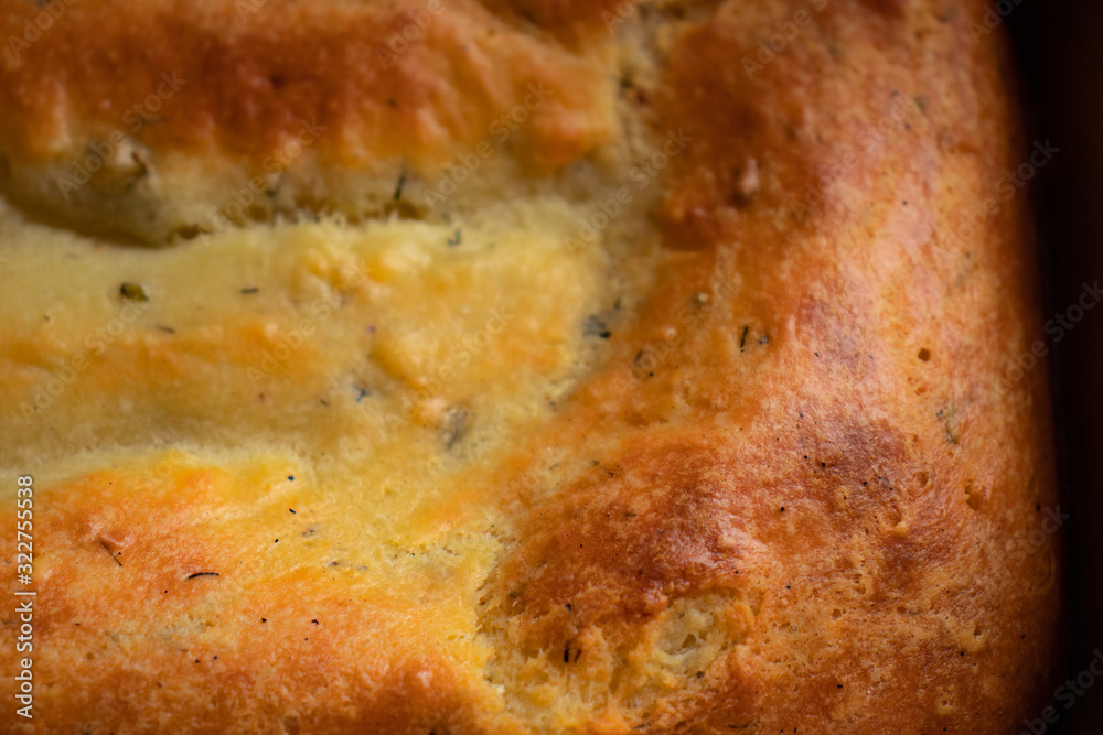 Close-up of fresh rosy ricotta cheese bread with greens and crispy crust