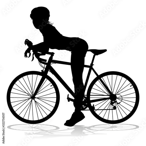 Bicyclist riding their bike and wearing a safety helmet in silhouette
