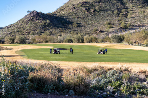 Canvastavla Golf foursome on the fairway in the desert on a clear day